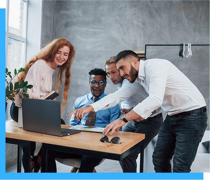 group of people sitting at desk talking