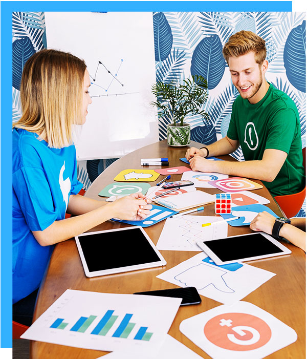 group of people sitting at desk talking