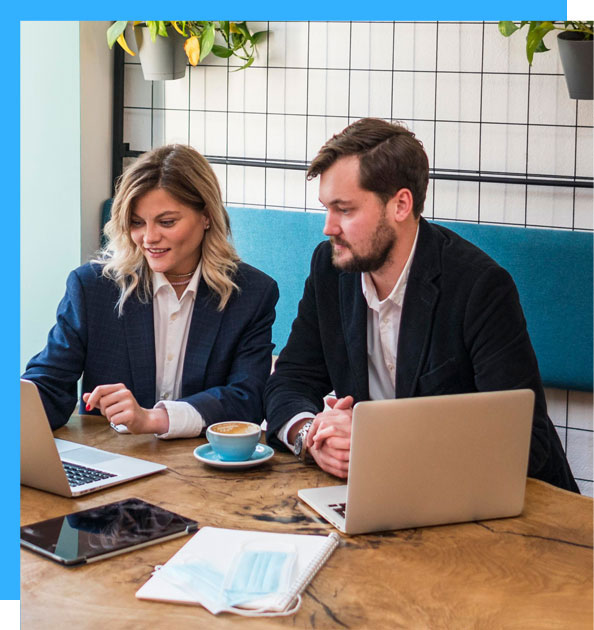 man and woman sitting in front of laptop